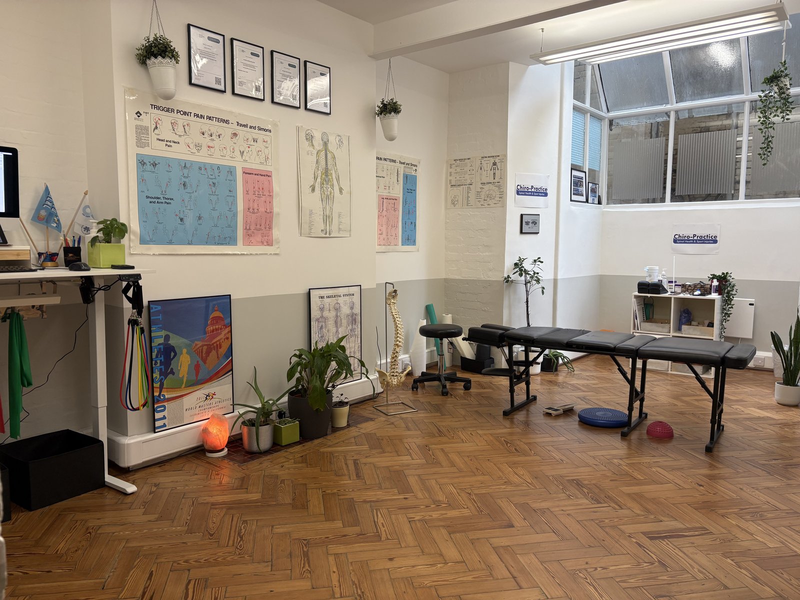 Spacious treatment room at the City of London clinic with an open floor, resistance bands and a treatment table